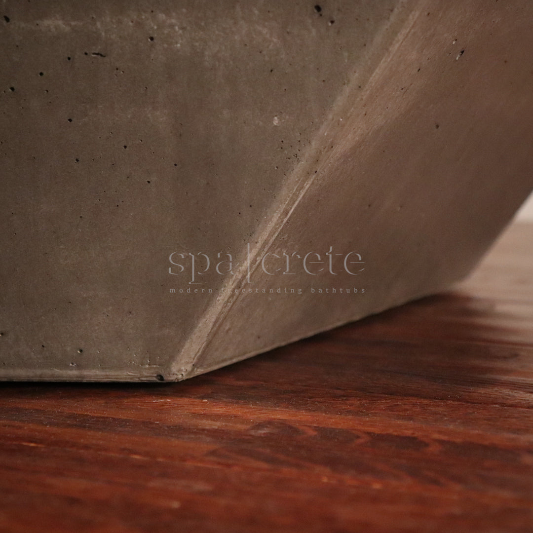 
                      Close-up image of the shadow gap at the bottom of SpaCrete's Geometric Freestanding Concrete Bathtub
                     
