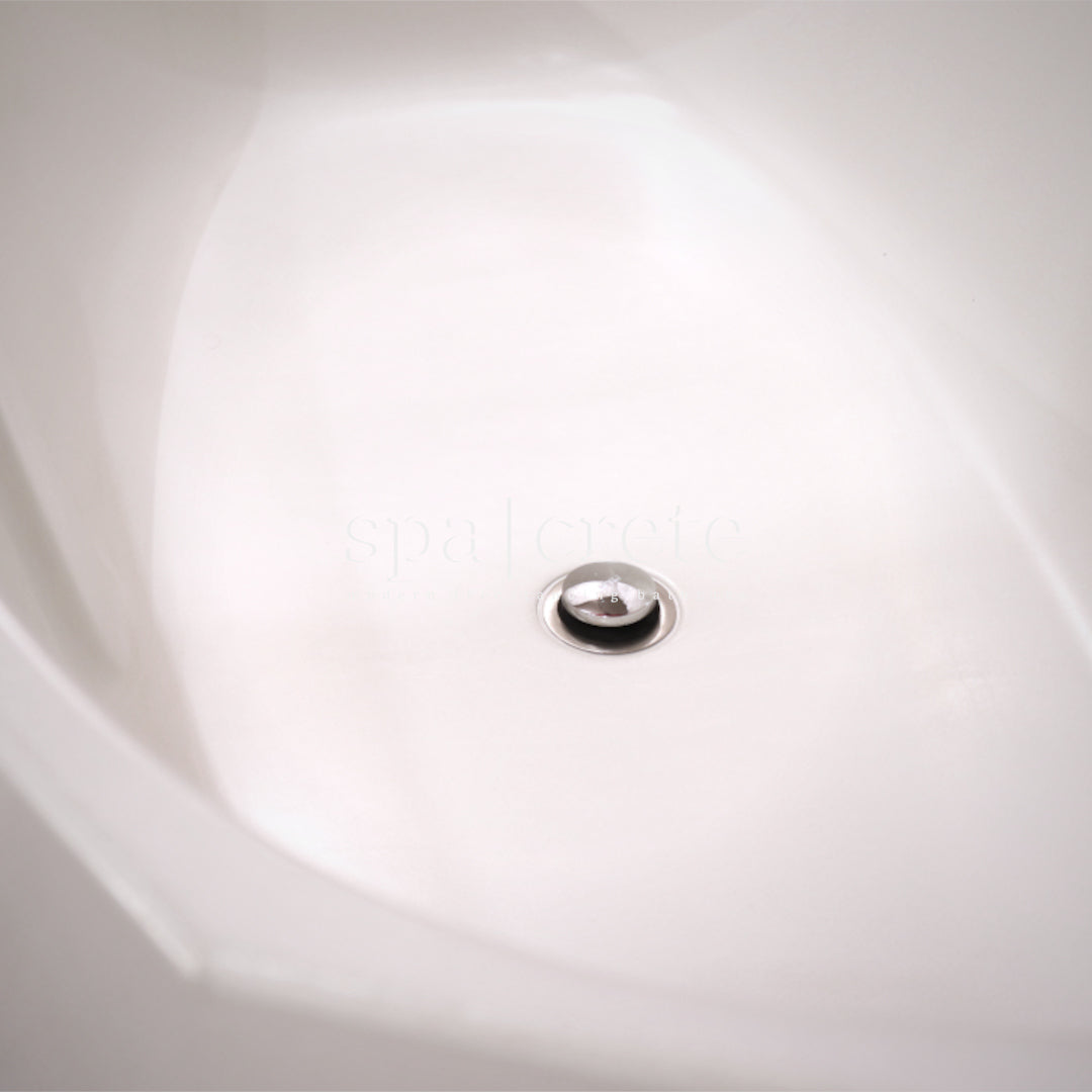 
                    
                     Angled interior view of SpaCrete Geometric concrete bathtub in Titanium White with centered drain
                    
                  